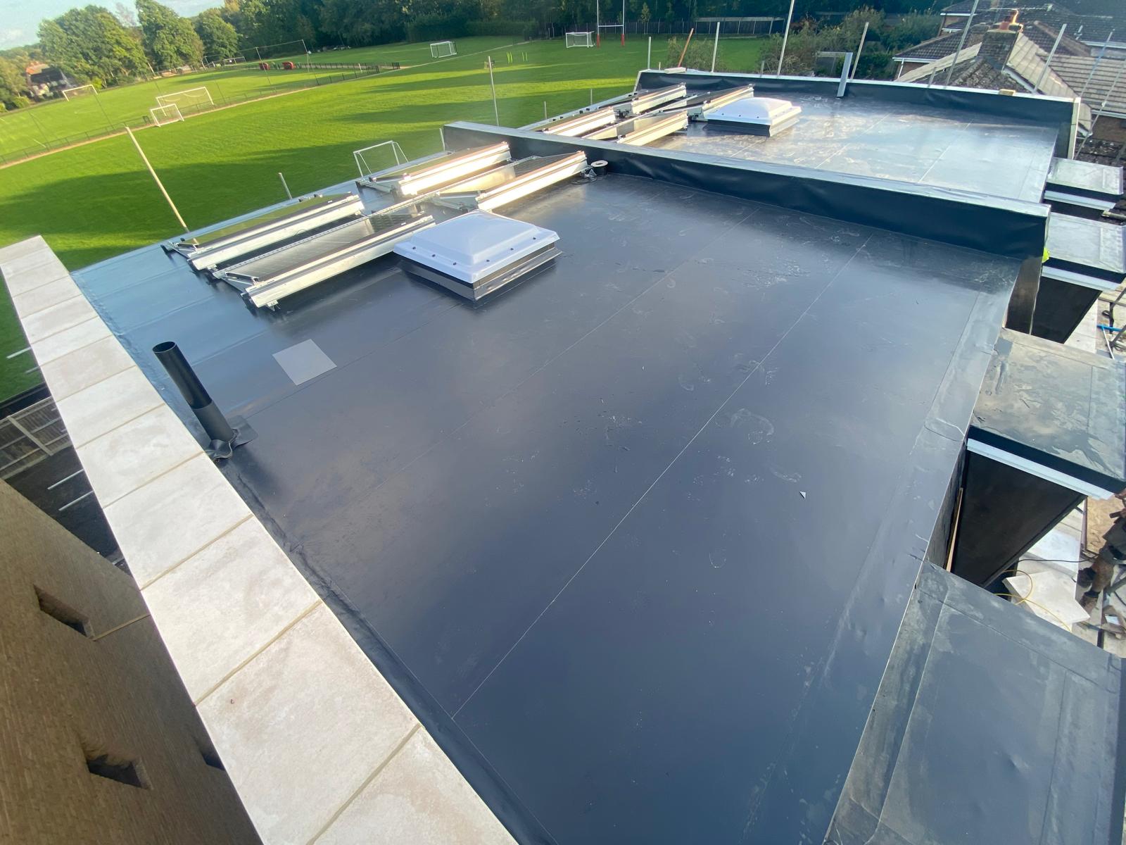 DM Roofing — large commercial flat roof with single ply membrane and dome rooflights