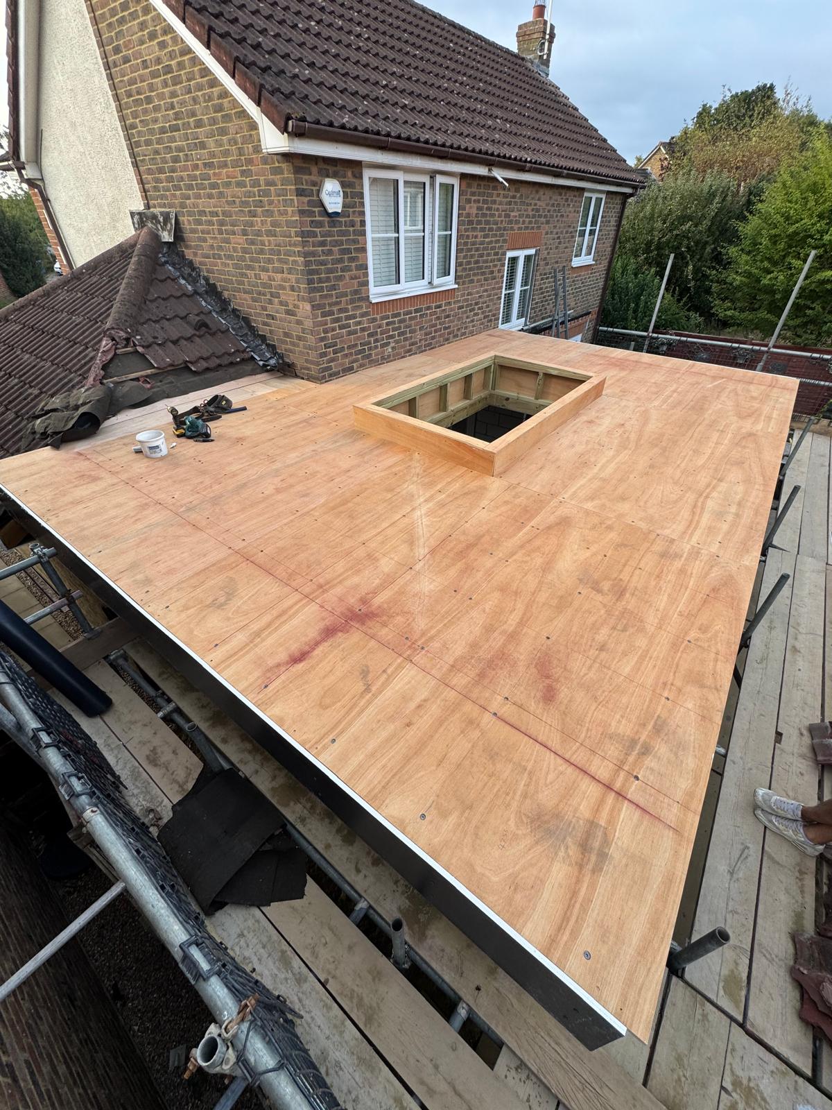 DM Roofing — flat roof plywood deck with rooflight opening before EPDM rubber membrane installation