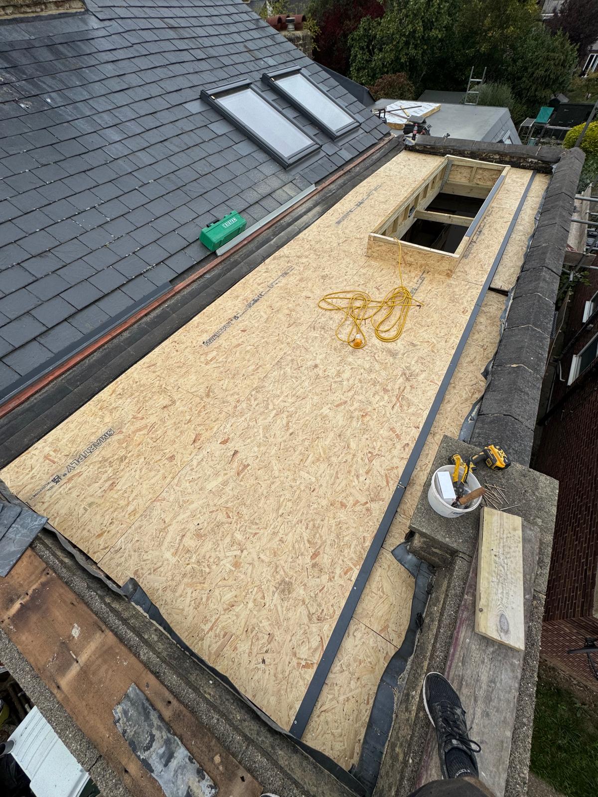 DM Roofing — OSB flat roof deck preparation with Velux windows before waterproofing membrane