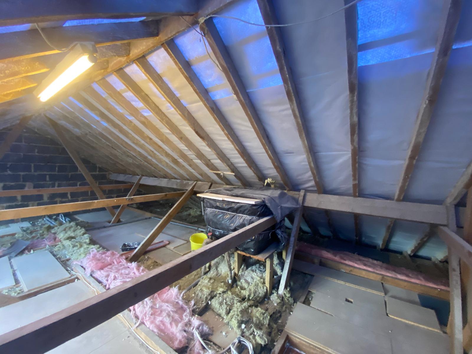 DM Roofing — completed natural slate re-roof, aerial view showing multiple roof sections with clean ridge lines and chimney lead flashing