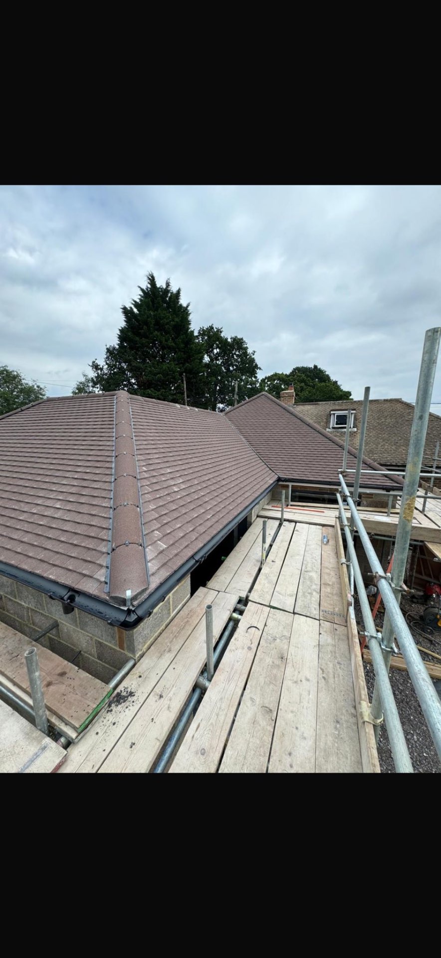 DM Roofing — new plain tile pitched roof installation with hip tiles, ridge work and guttering, residential property
