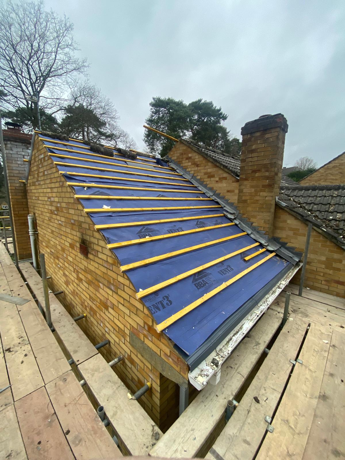 DM Roofing — new BBA Vent3 breathable membrane and yellow timber battens laid on stripped roof, ready for slating