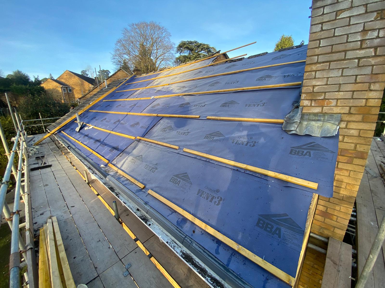 DM Roofing team fixing battens to breathable membrane on large residential re-roof project
