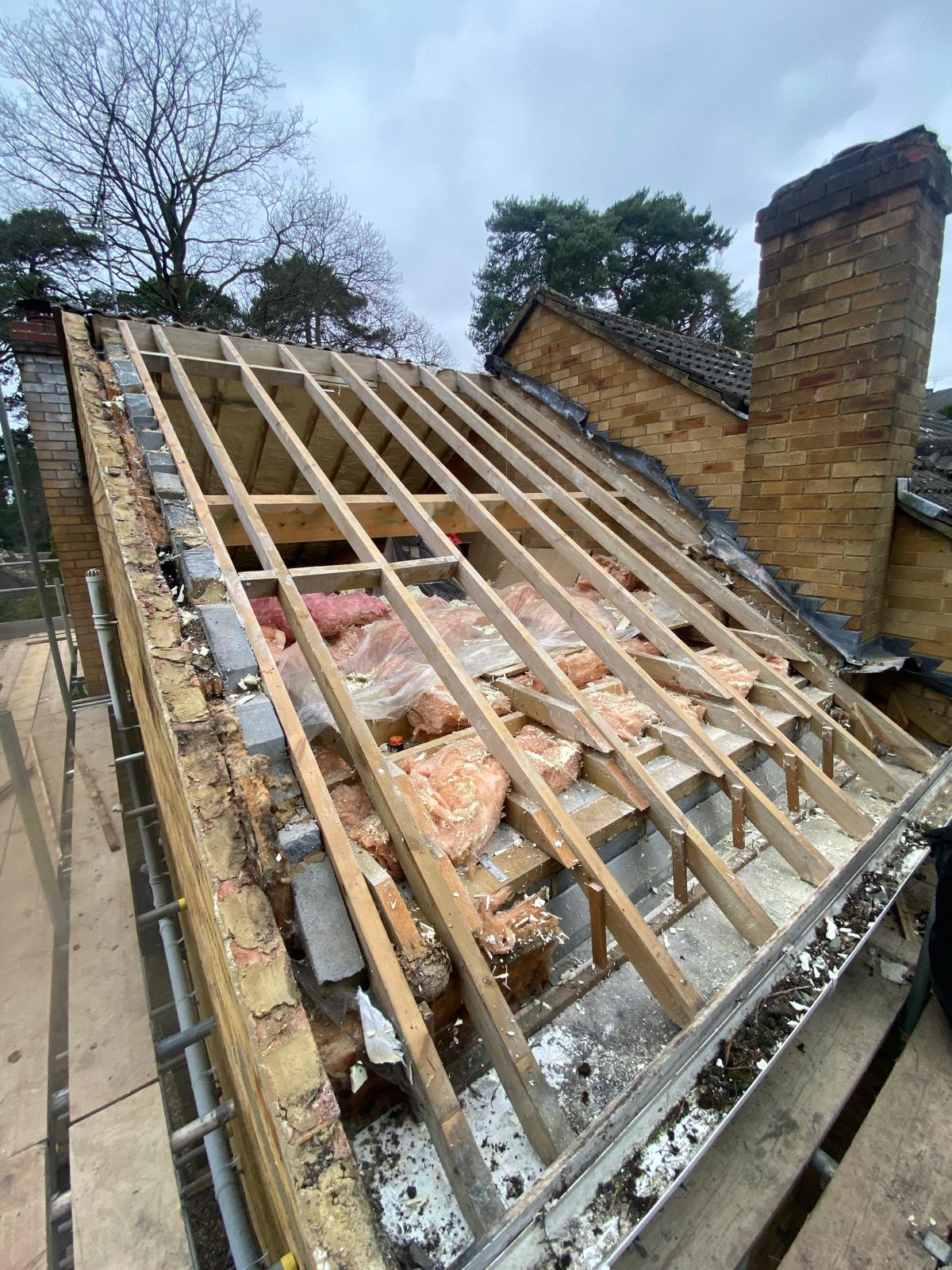 DM Roofing — full roof strip showing bare rafters and exposed insulation before Russell Grampian re-tile and spray foam removal